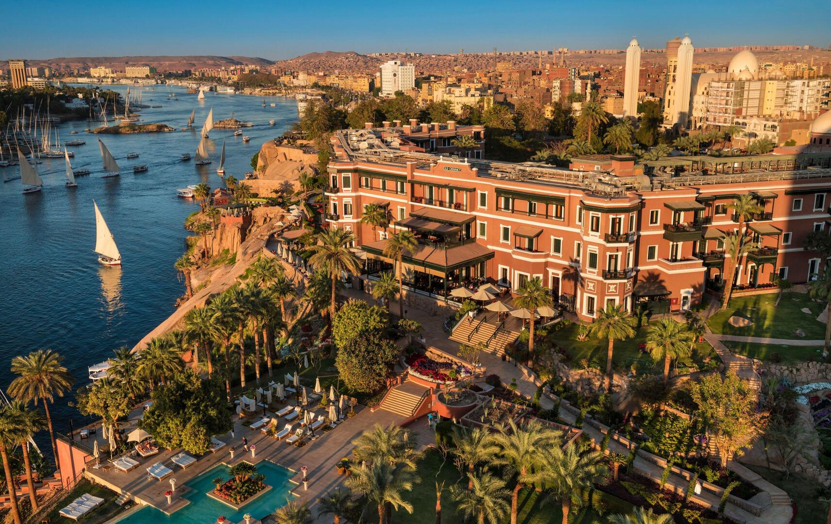 Aerial view of the Sofitel Legend Old Cataract Hotel in Aswan, Egypt, overlooking the Nile River and Elephantine Island.