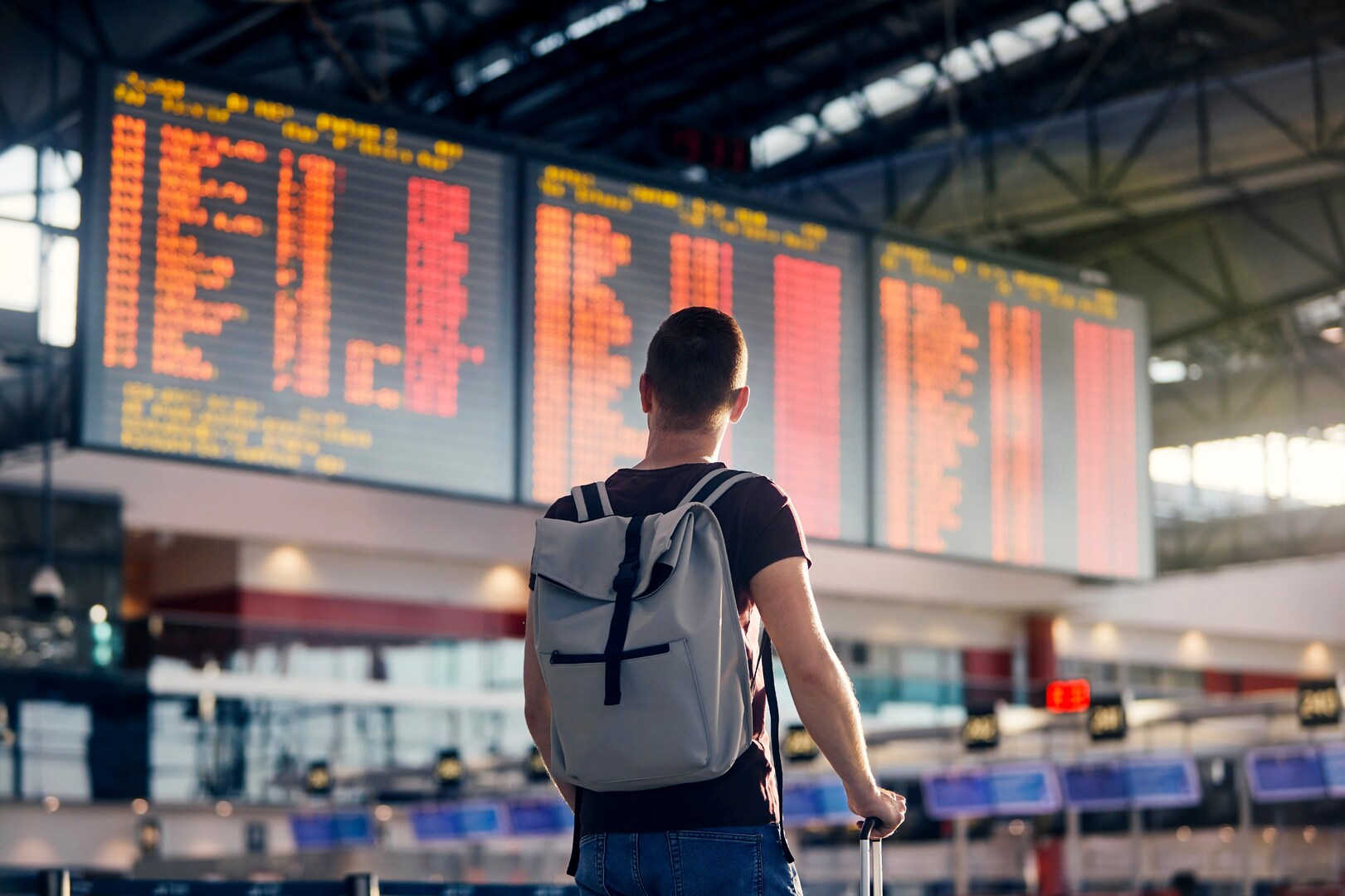A traveller looks at an airport departures board