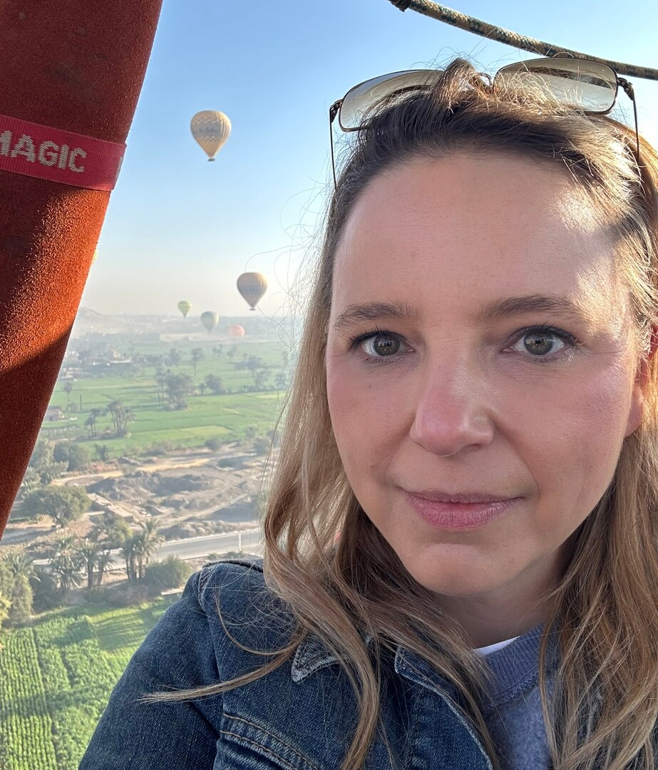 Woman in hot air balloon over Nile Valley, Egypt.