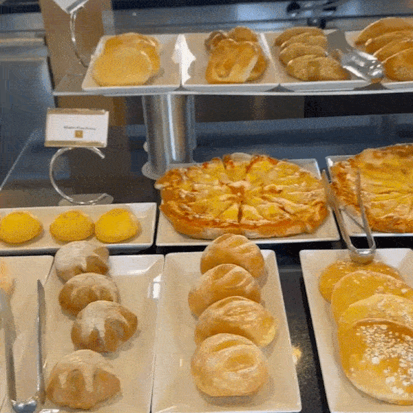 Assortment of pastries and breads at a buffet.