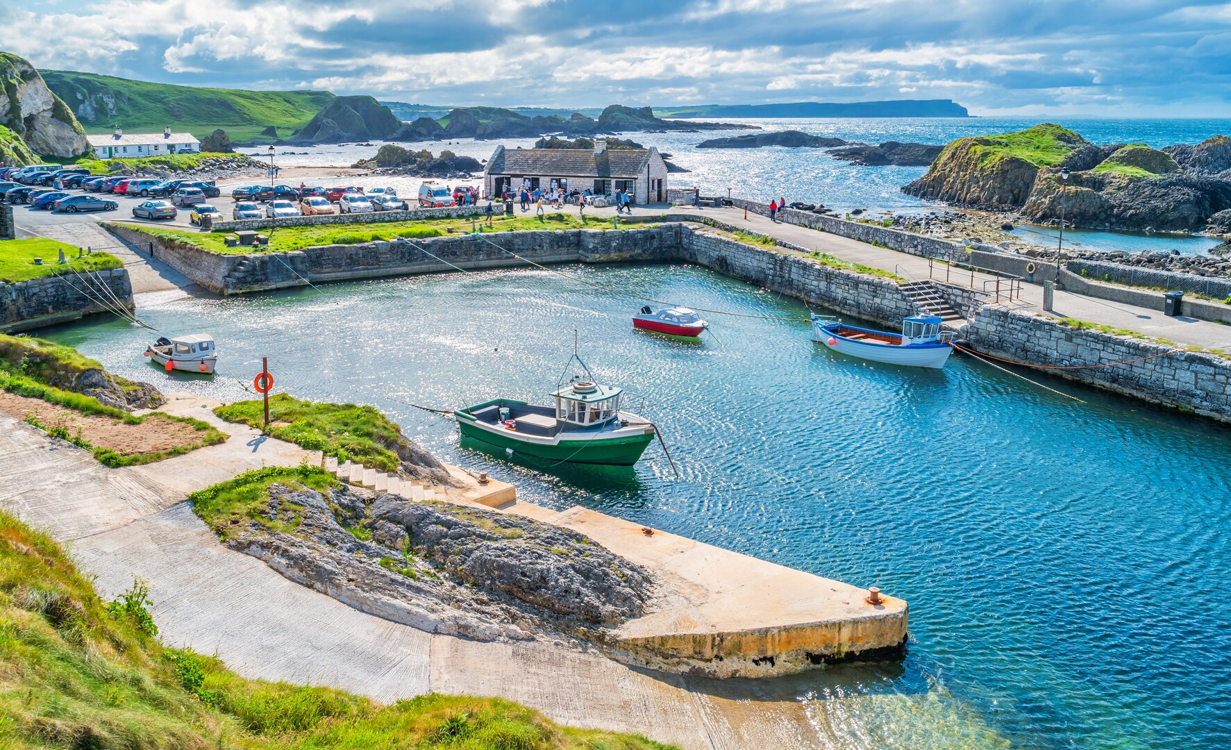 Ballintoy Harbour in Northern Ireland with boats in the harbor.